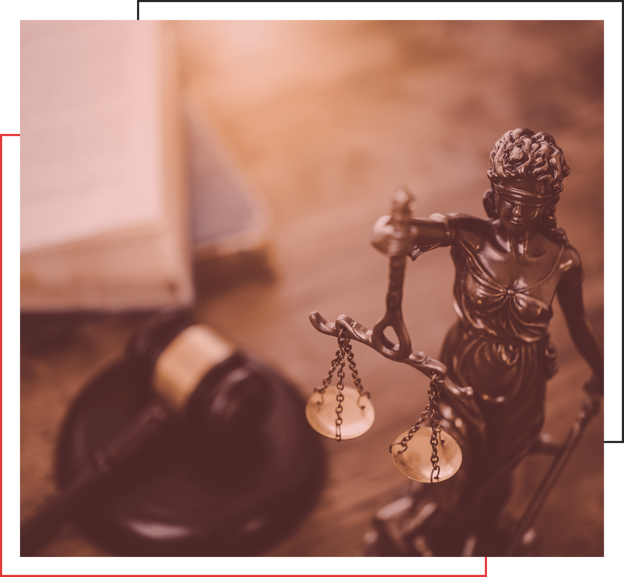 A close-up of a bronze Lady Justice statue holding balanced scales in one hand and a sword in the other